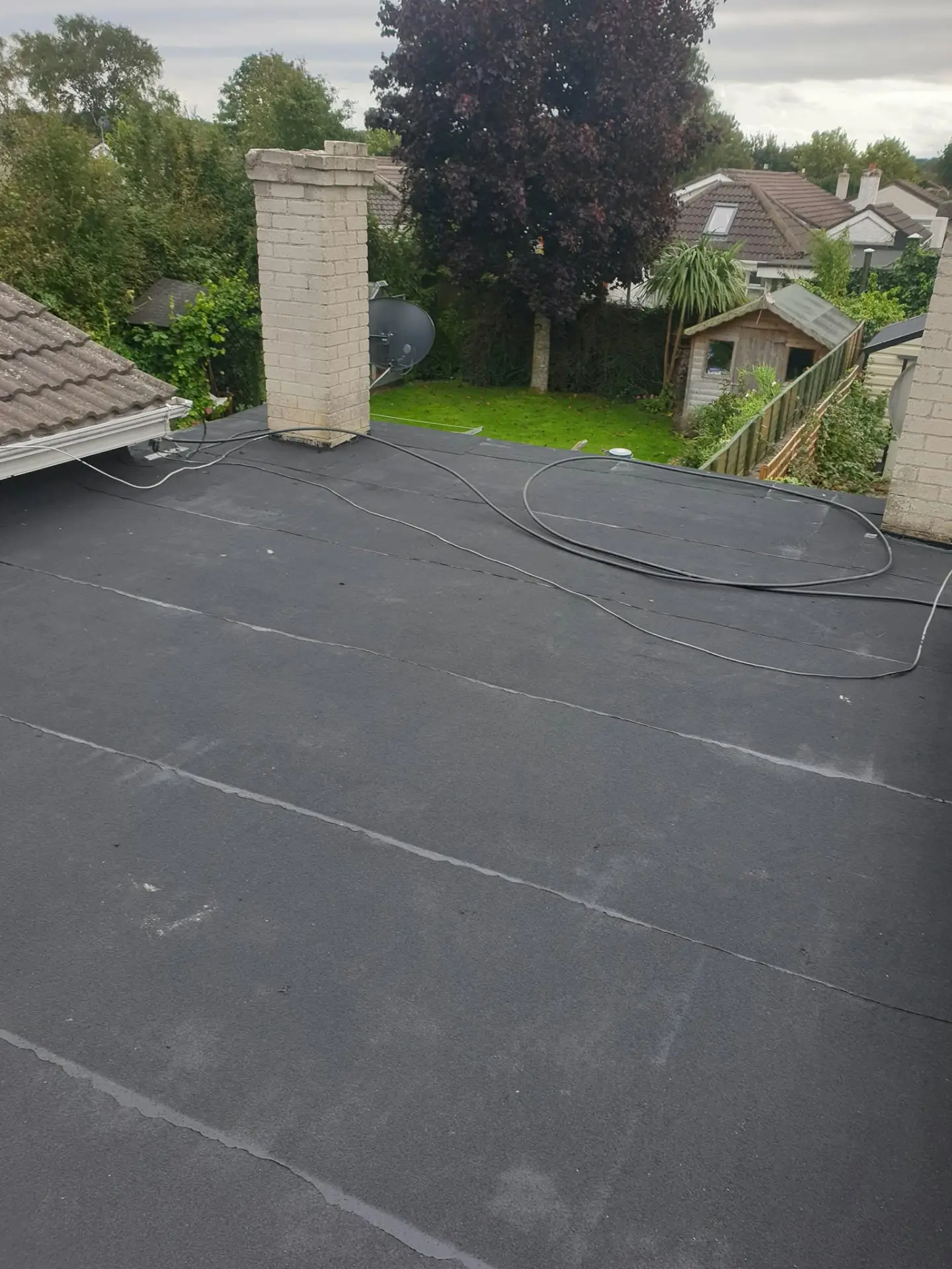 New torch-on felt flat roof finished around a chimney in Dublin